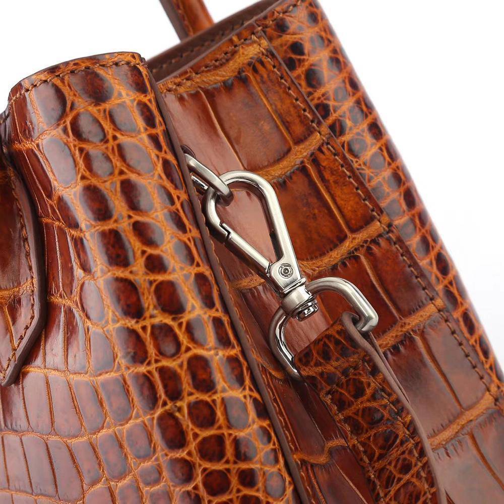 Brown women's mini top handle tote bag by Rossie Viren, showing a stylish handbag with a compact design and top handle.