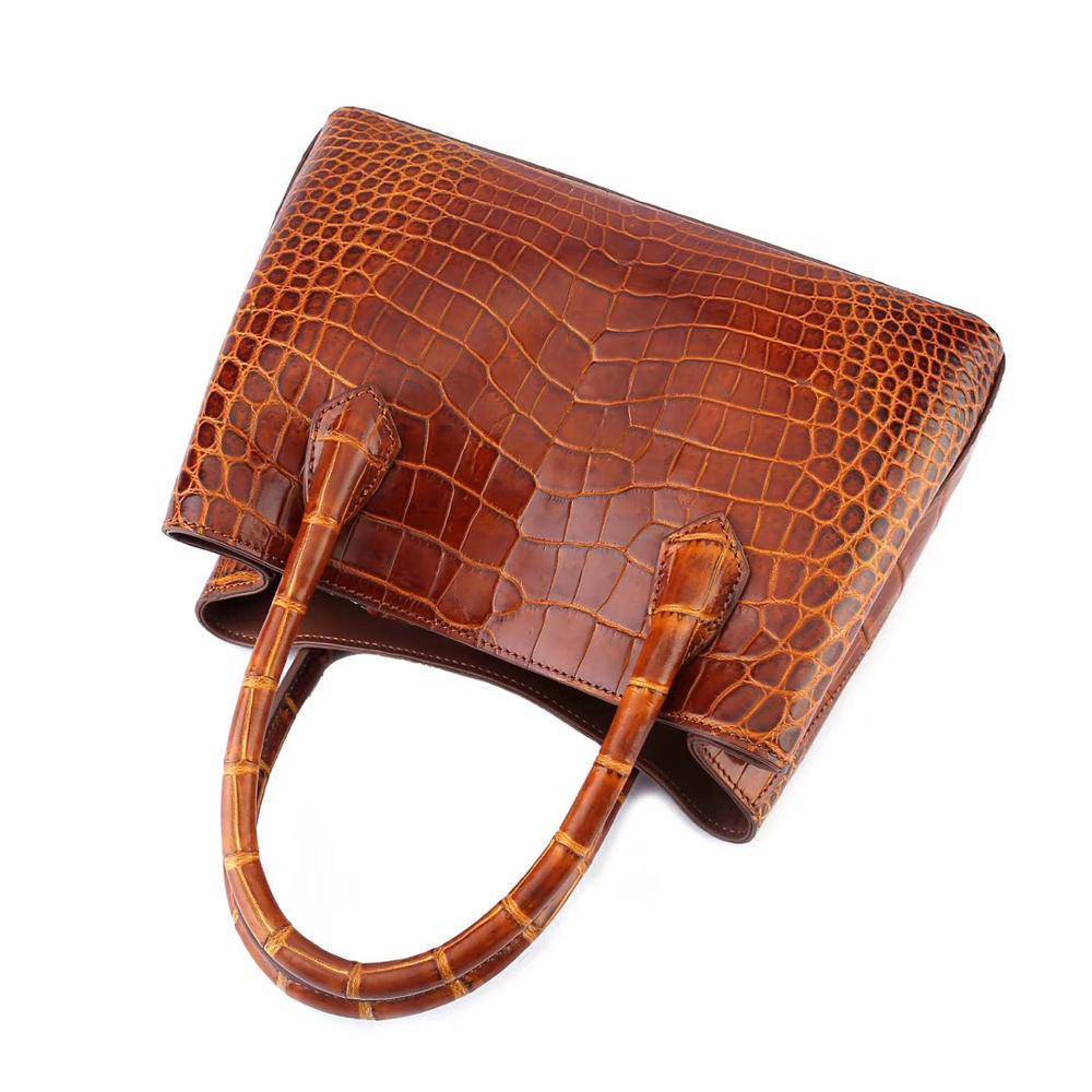 Brown women's mini top handle tote bag by Rossie Viren, featuring a compact design and elegant handbag style.