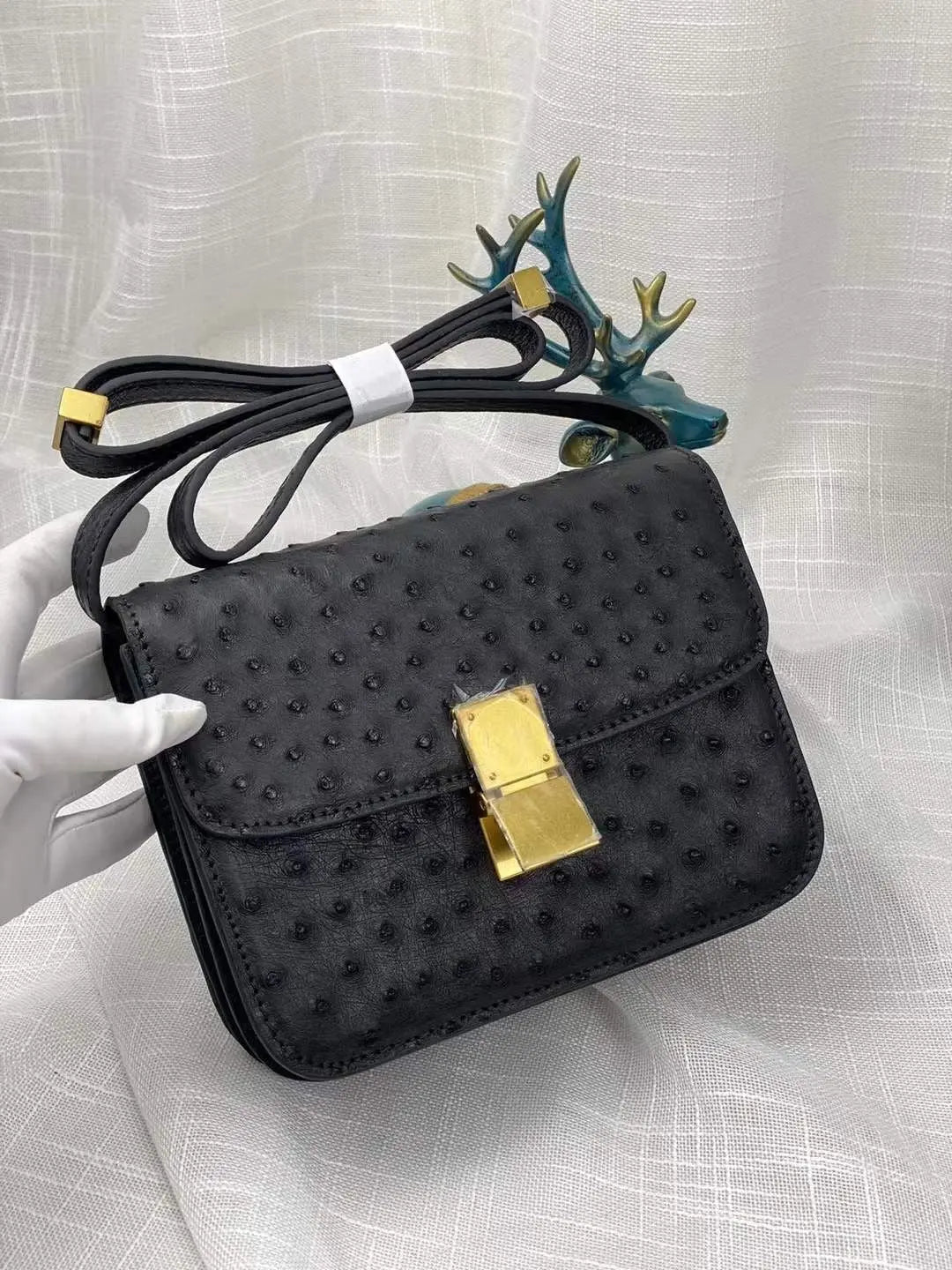 Women’s ostrich leather cross body messenger handbag by Rossie Viren with adjustable shoulder strap and sleek design.