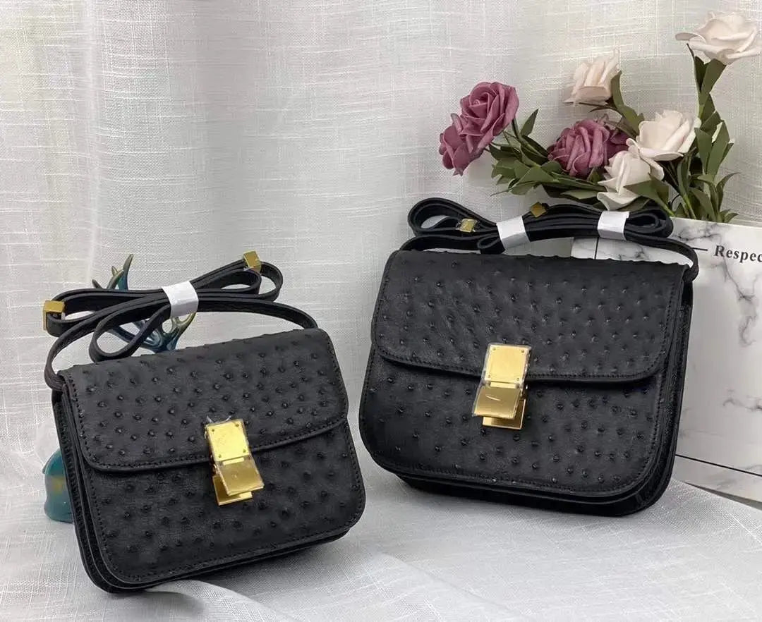 Women’s ostrich leather cross body messenger handbag by Rossie Viren with adjustable shoulder strap and sleek design.