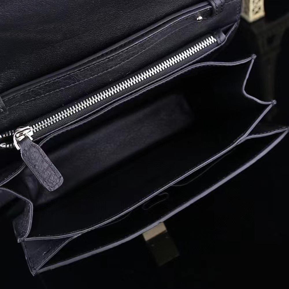 Women's ostrich leather crossbody messenger bag by Rossie Viren, featuring a sleek shoulder strap and textured exotic leather.