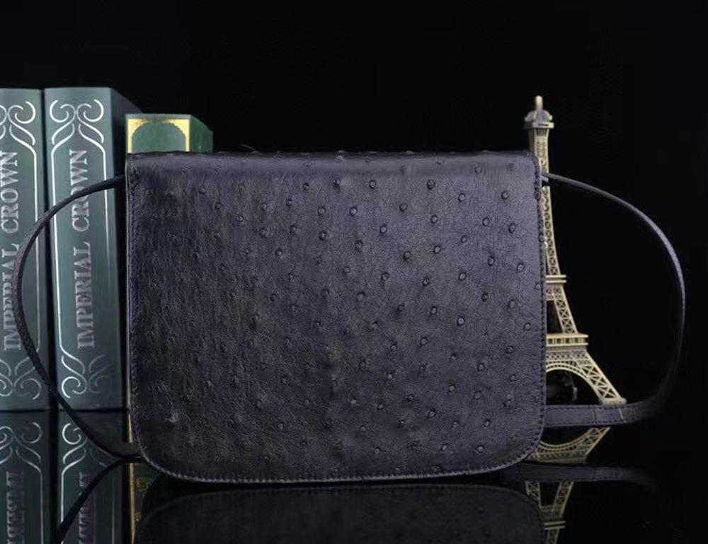 Women's ostrich leather cross body messenger handbag by Rossie Viren with adjustable shoulder strap and sleek design.