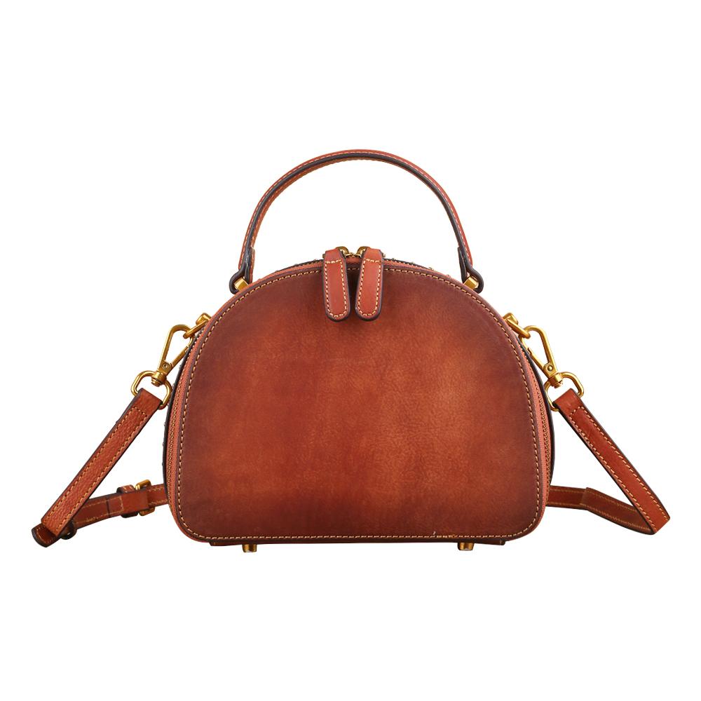 Rossie Viren women's vintage mini half-moon crossbody shoulder bag with studded details and top handle design.