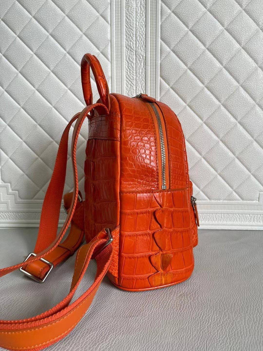 Orange and wine red crocodile leather handbag by Rossie Viren featuring a stylish women's backpack with textured finish.