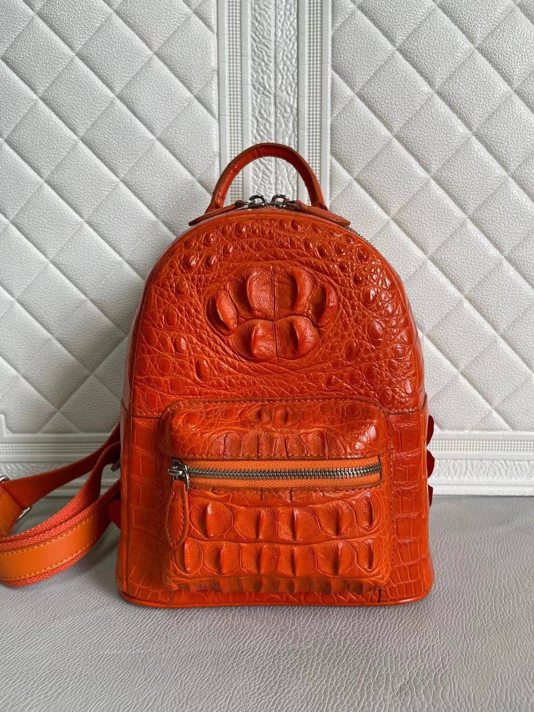 Orange and wine red crocodile leather women's handbag backpack by Rossie Viren, showing textured crocodile pattern and adjustable straps.