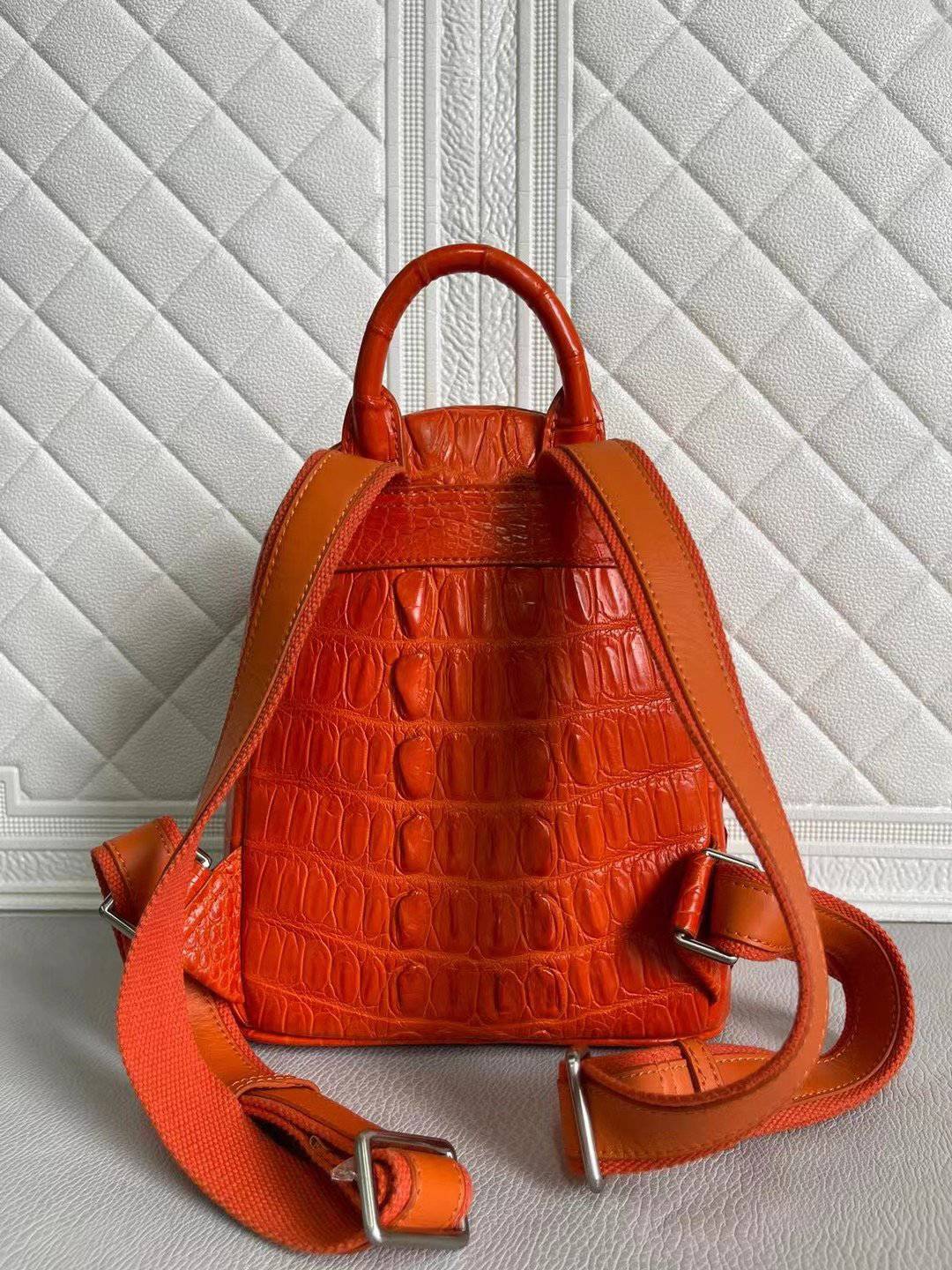 Orange and wine red crocodile leather handbag for women by Rossie Viren, featuring a stylish, textured backpack design.