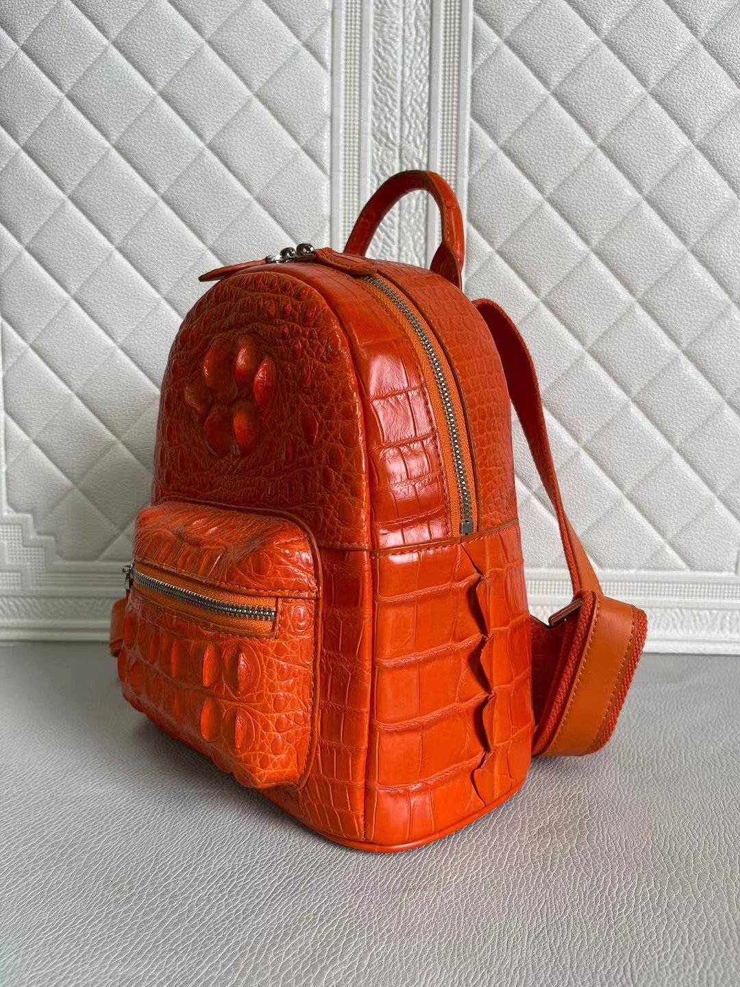 Orange and wine red crocodile leather handbag by Rossie Viren featuring a stylish women's backpack design.