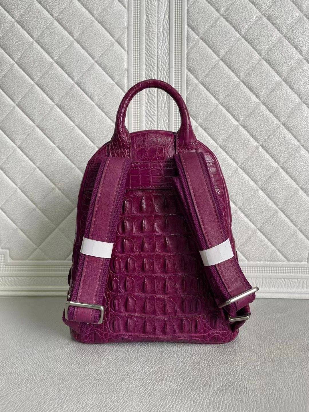 Women's crocodile leather handbag in orange and wine red by Rossie Viren, showing the textured leather and structured design.