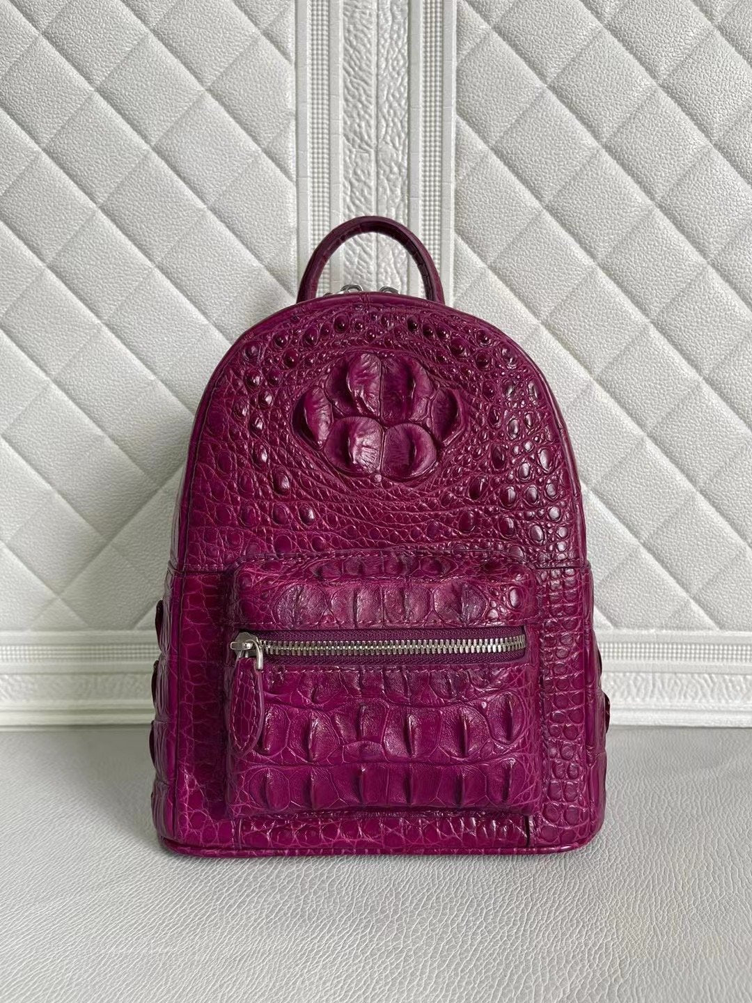 Women’s crocodile leather handbag in orange and wine red with a stylish backpack design by Rossie Viren.
