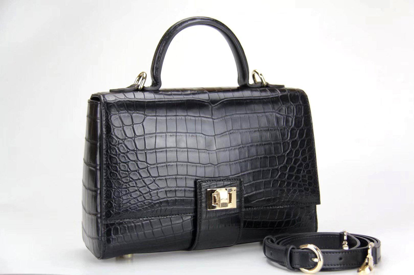 Women’s crocodile leather messenger handbag with crossbody strap and top handle by Rossie Viren, featuring a sleek, textured design.