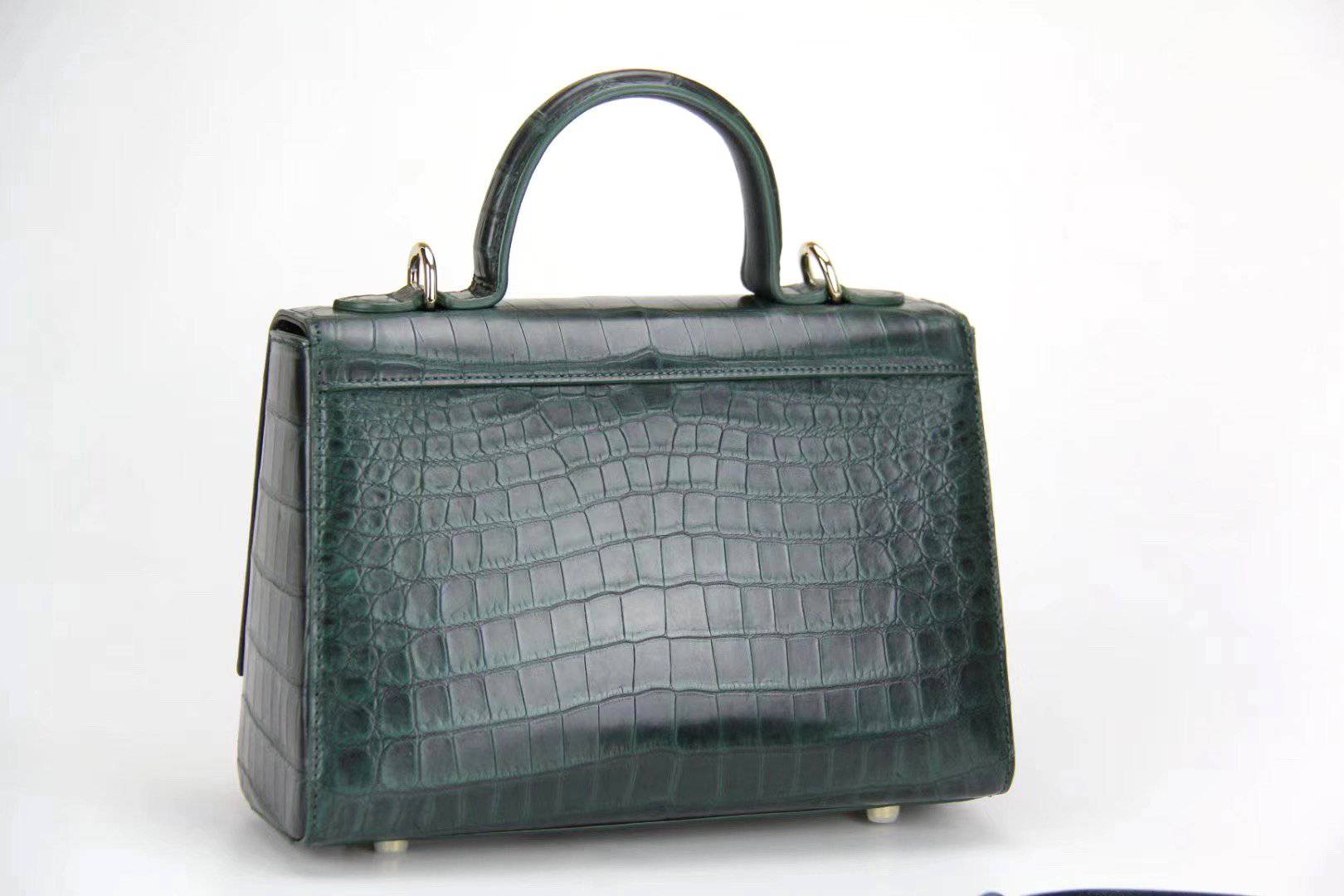 Women's crocodile leather messenger handbag with crossbody strap and top handle by Rossie Viren, showcasing sleek and textured design.