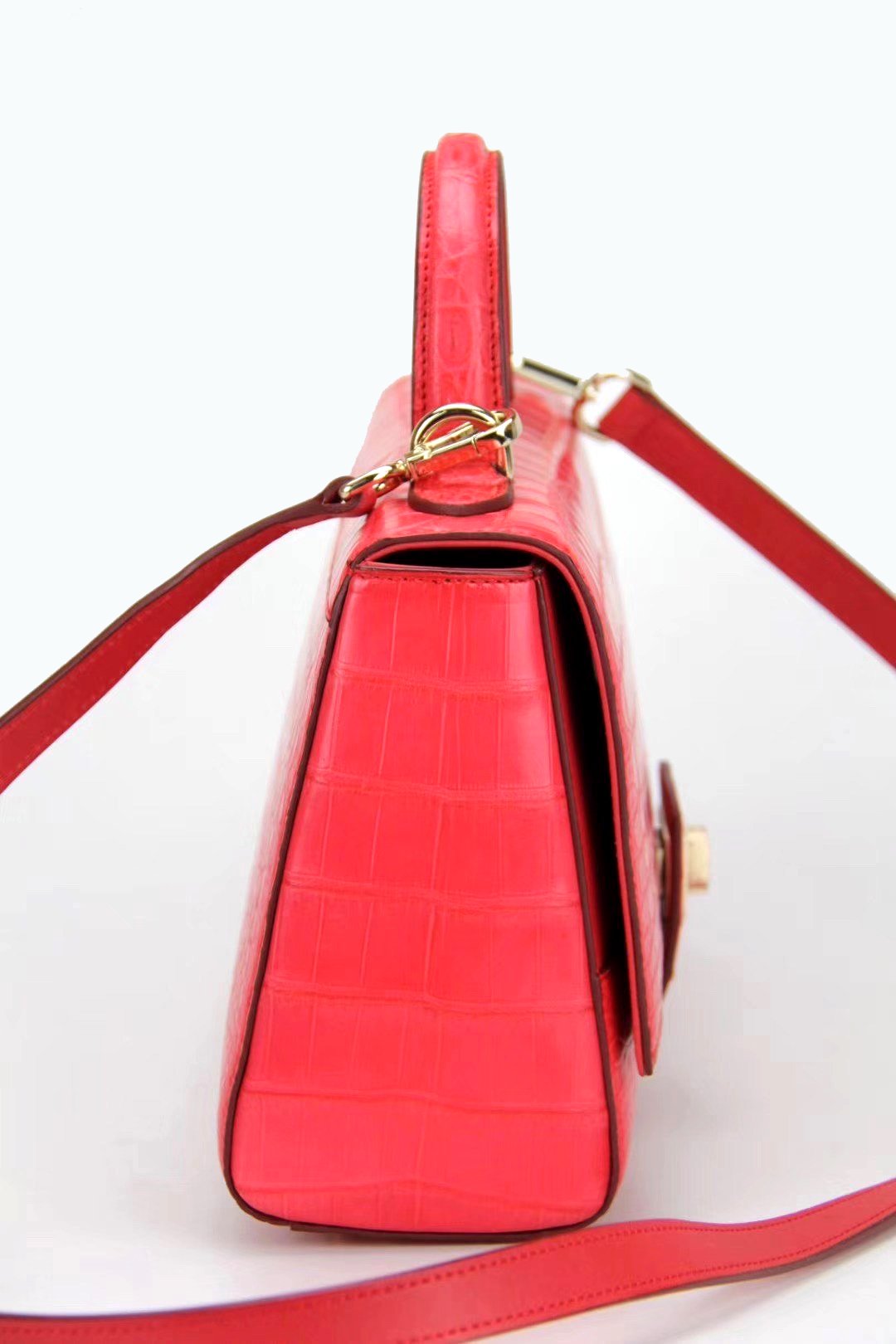 Women's crocodile leather messenger handbag with cross-body strap and top handle by Rossie Viren, showcasing a stylish and elegant design.