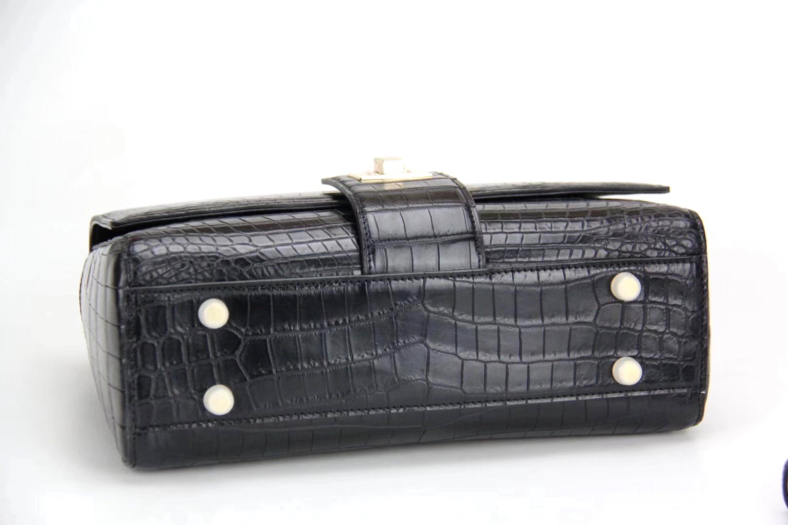 Women's crocodile leather messenger handbag with crossbody and top handle by Rossie Viren, featuring a sleek, structured design.