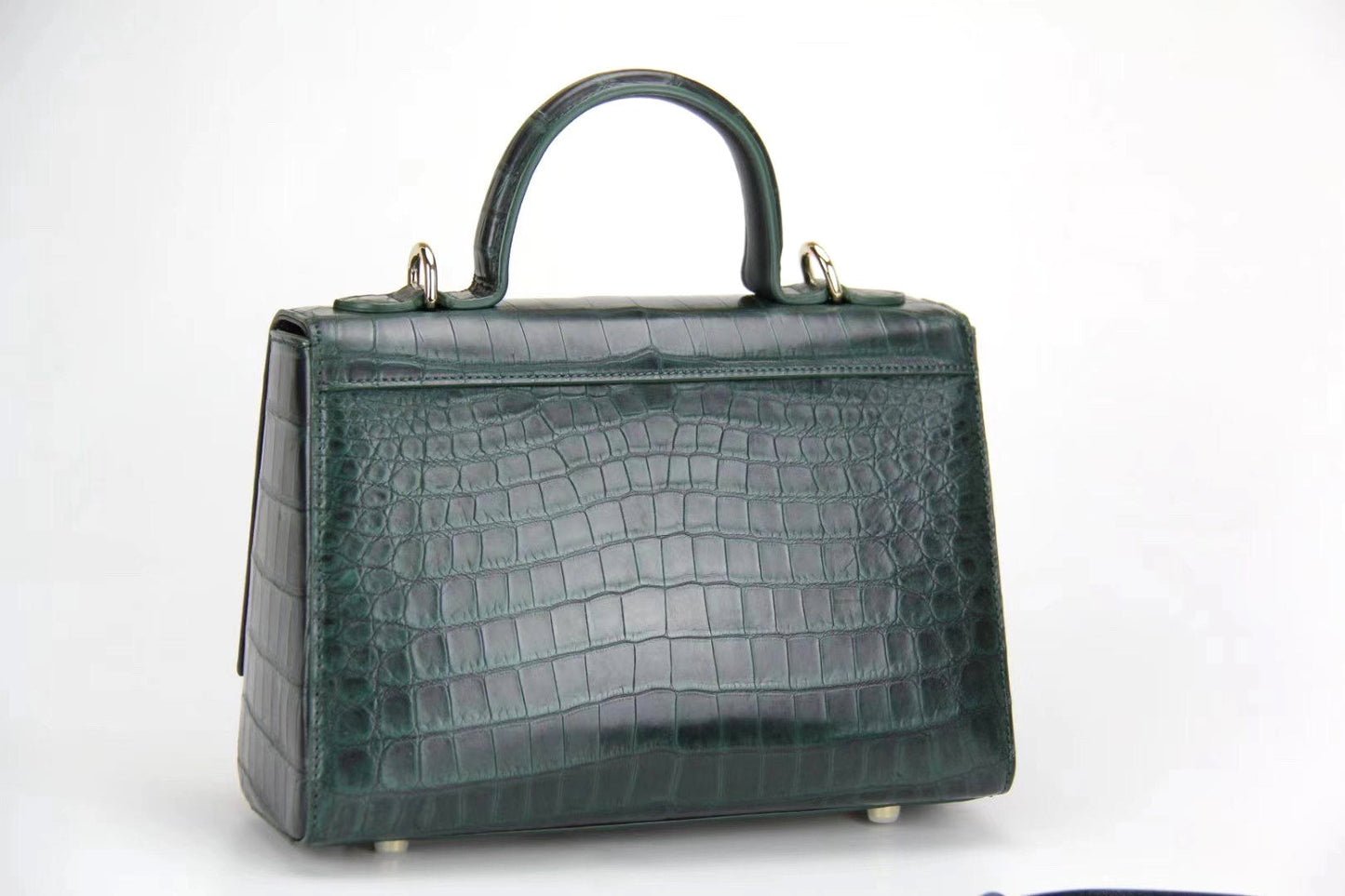 Women's crocodile leather messenger handbag by Rossie Viren with crossbody strap and top handle, stylish and functional.