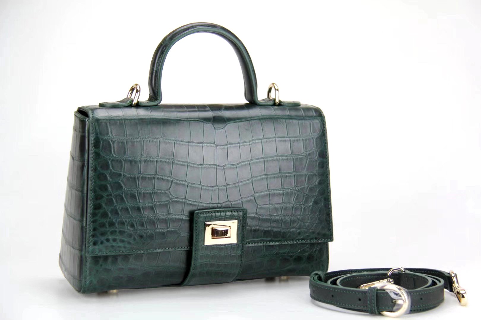 Women's crocodile leather messenger handbag with crossbody strap and top handle by Rossie Viren, showcasing its elegant design.