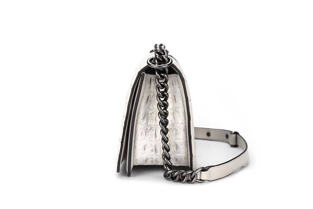 Women’s crocodile leather shoulder flap chain bag by Rossie Viren with a stylish design and gold chain strap.