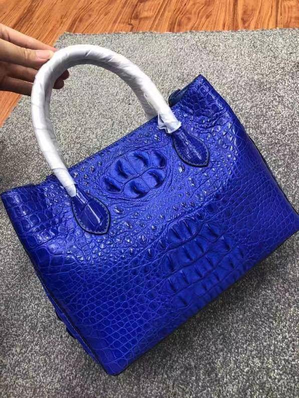 Large women's crocodile skin leather satchel bag by Rossie Viren, showcasing textured crocodile pattern and spacious design.