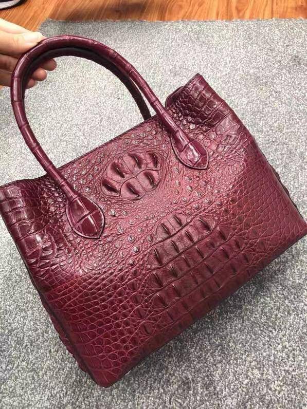 Large women's crocodile skin leather satchel bag by Rossie Viren, showcasing textured crocodile pattern and sturdy carry handles.