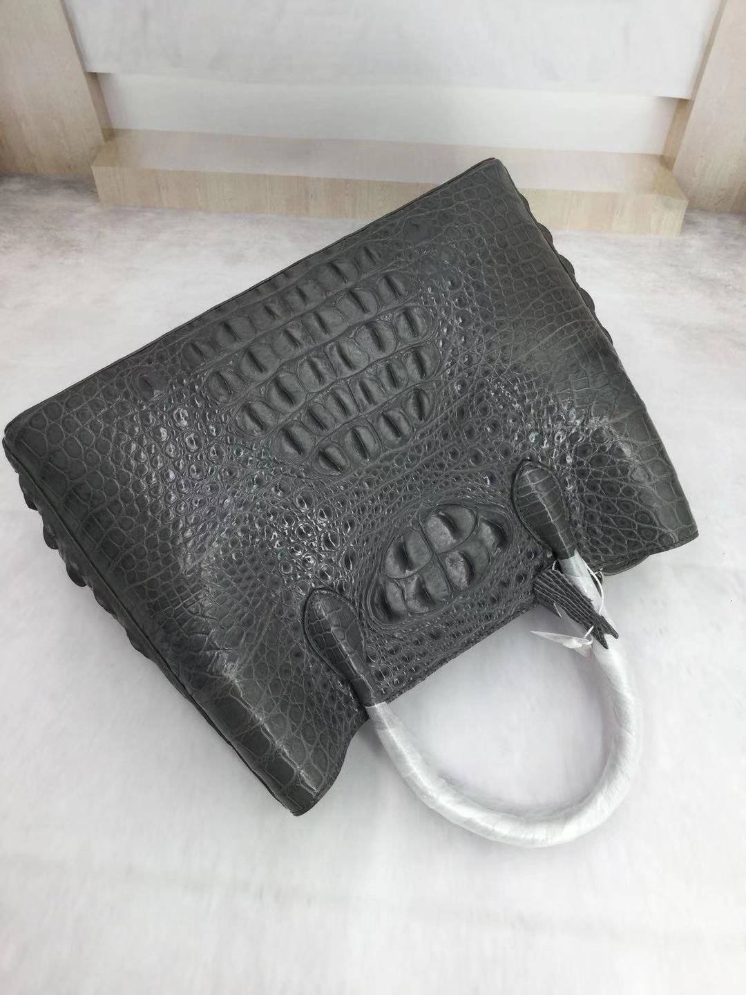 Large women's crocodile skin leather satchel bag by Rossie Viren, featuring a structured design and top handles.