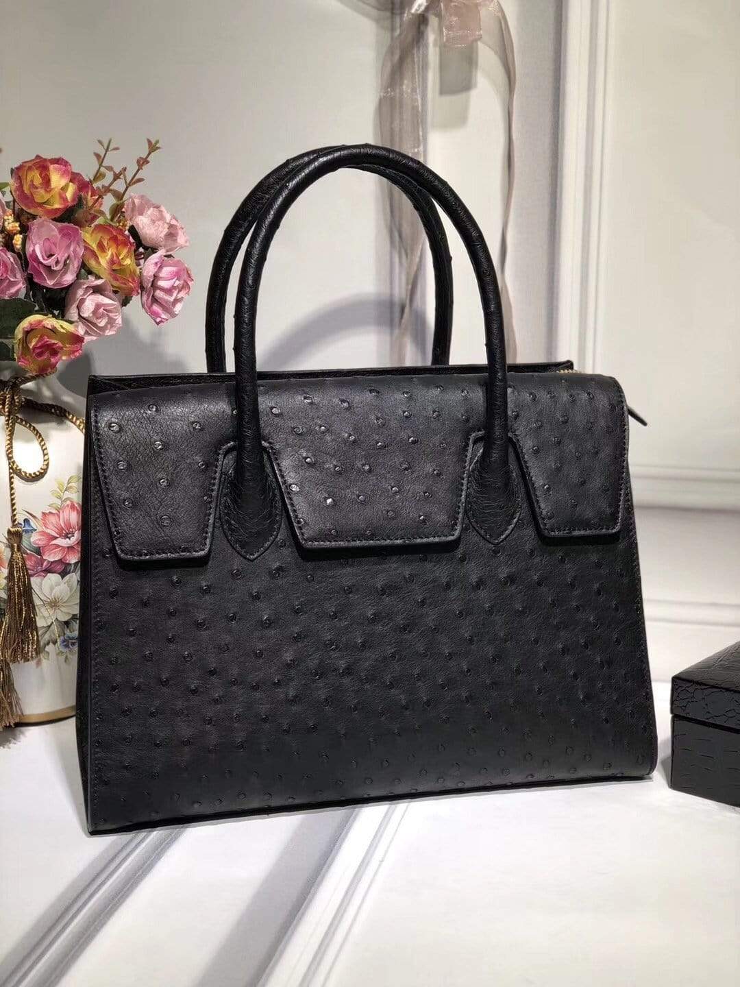 Women's genuine ostrich leather handbag with flap closure, zipper detail, and tote style by Rossie Viren.