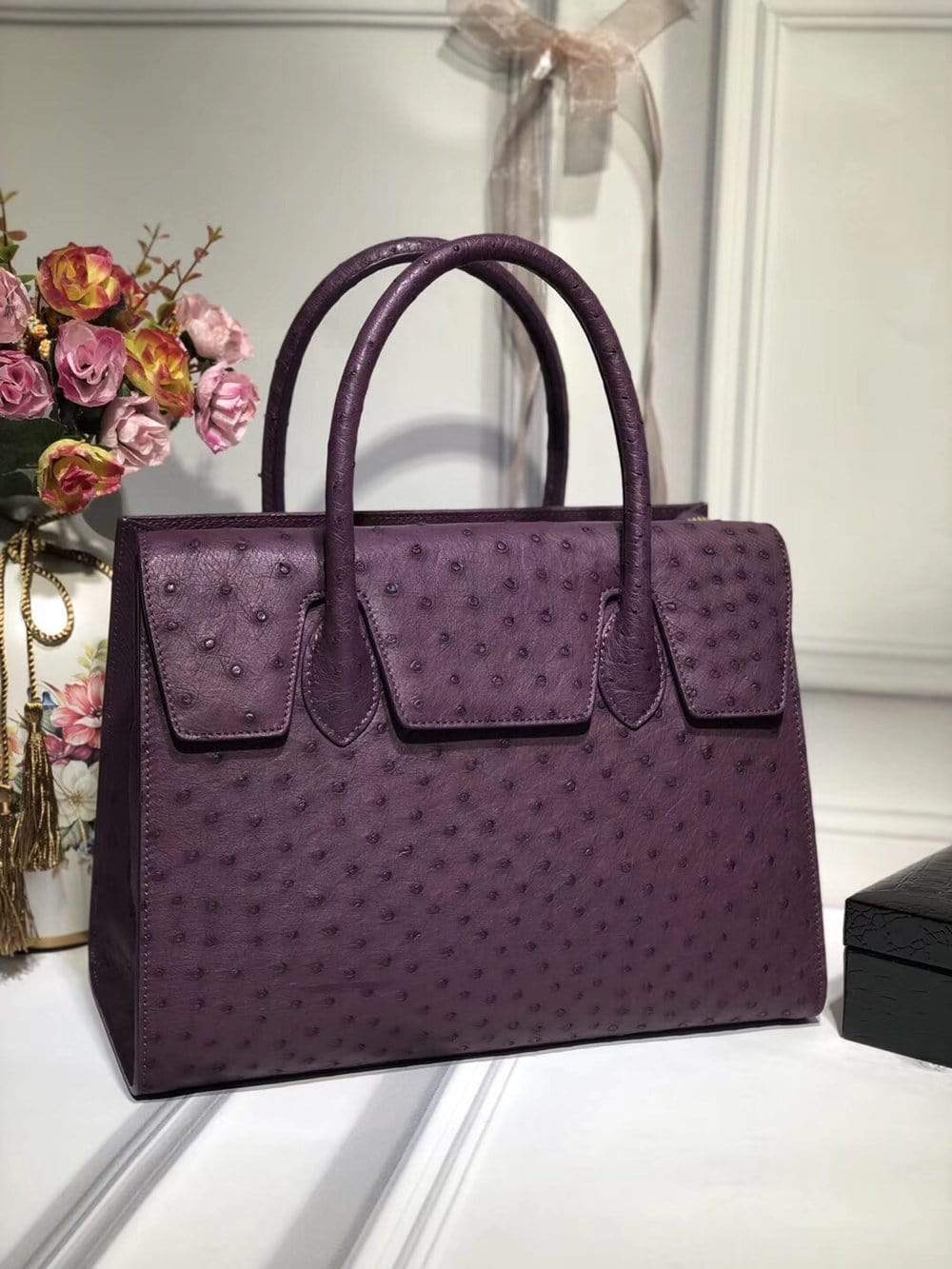 Women’s genuine ostrich leather handbag with flap over zipper closure and tote style, by Rossie Viren.