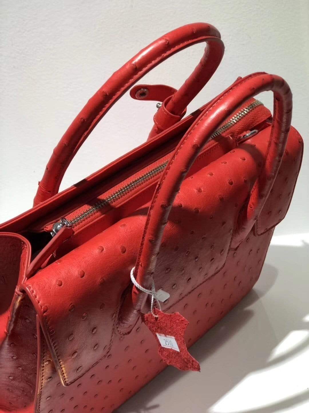 Women's genuine ostrich leather flap-over zipper satchel tote bag by Rossie Viren, featuring textured leather and stylish design.