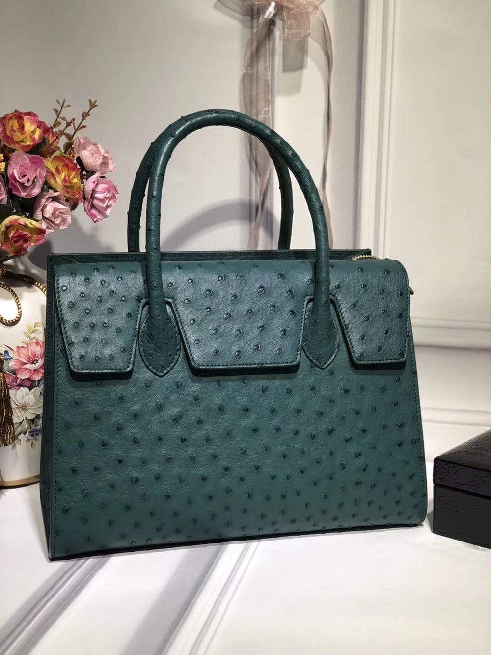 Women's genuine ostrich leather handbag with flap, zipper closure, and tote design by Rossie Viren.