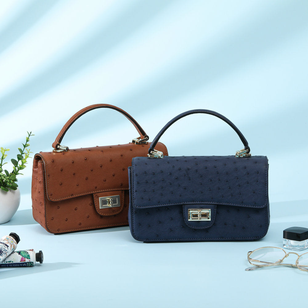 Women's ostrich leather mini flap chain handbag with top handle and crossbody strap by Rossie Viren.