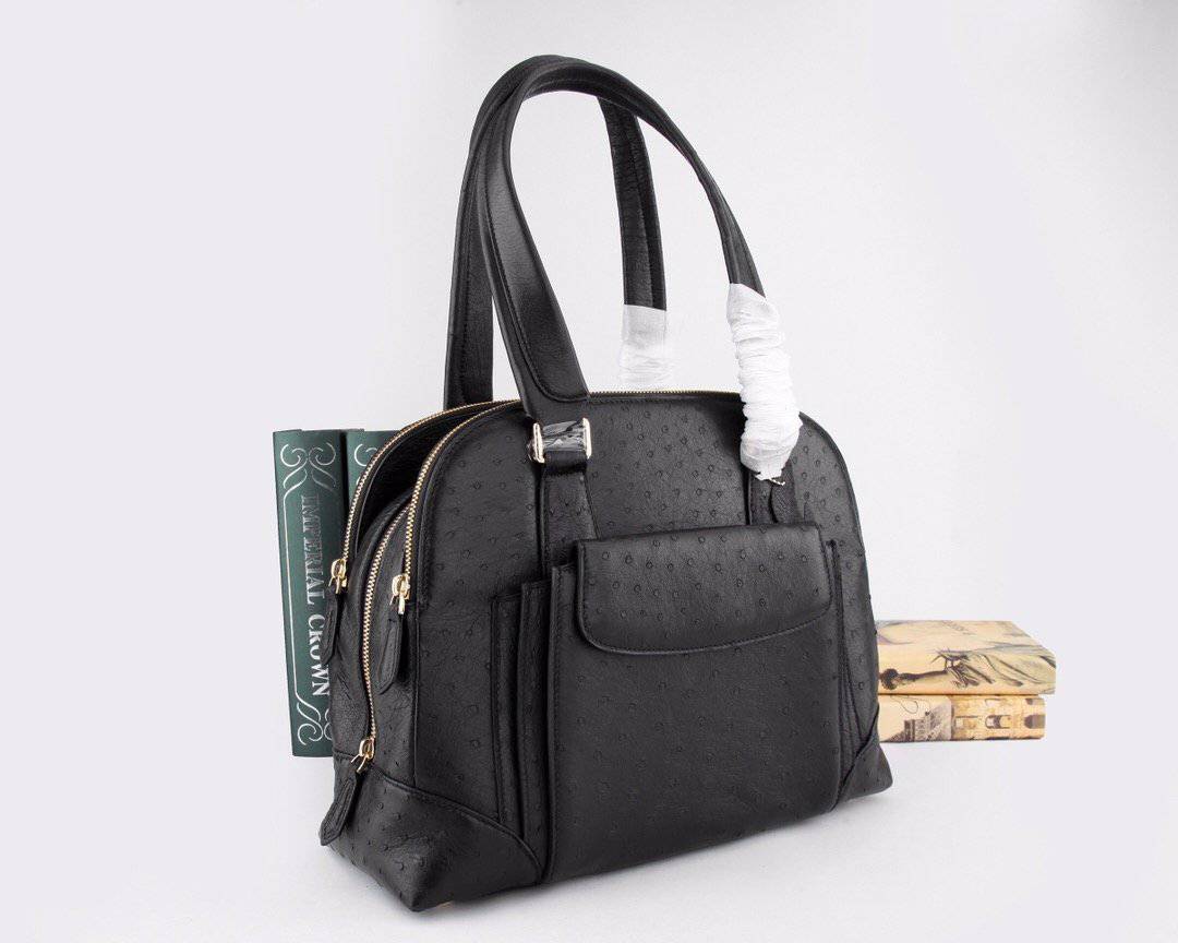 Women's ostrich leather shoulder handbag with top handle by Rossie Viren, featuring a sleek, textured leather design.