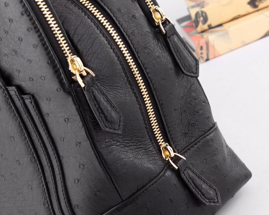 Women's ostrich leather shoulder bag with top handle, stylish handbag by Rossie Viren featuring textured leather and elegant design.