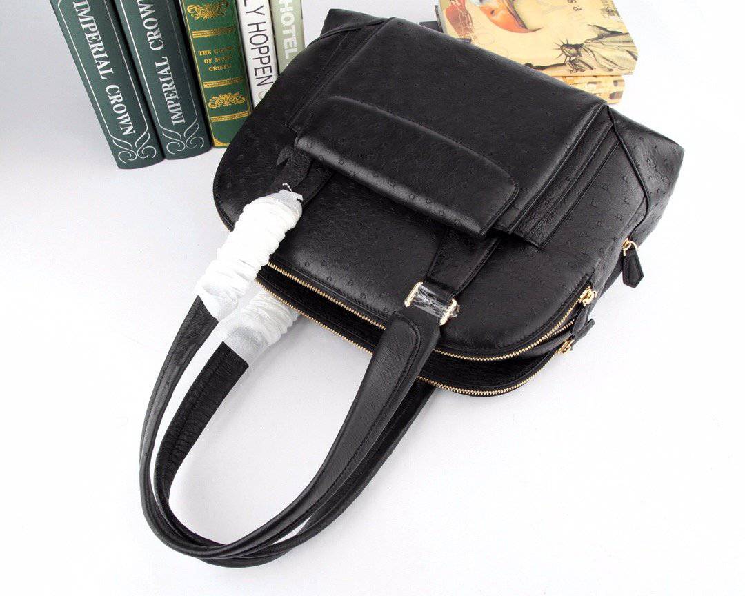Women’s ostrich leather handbag with top handle and shoulder strap by Rossie Viren, featuring a sleek, structured design.