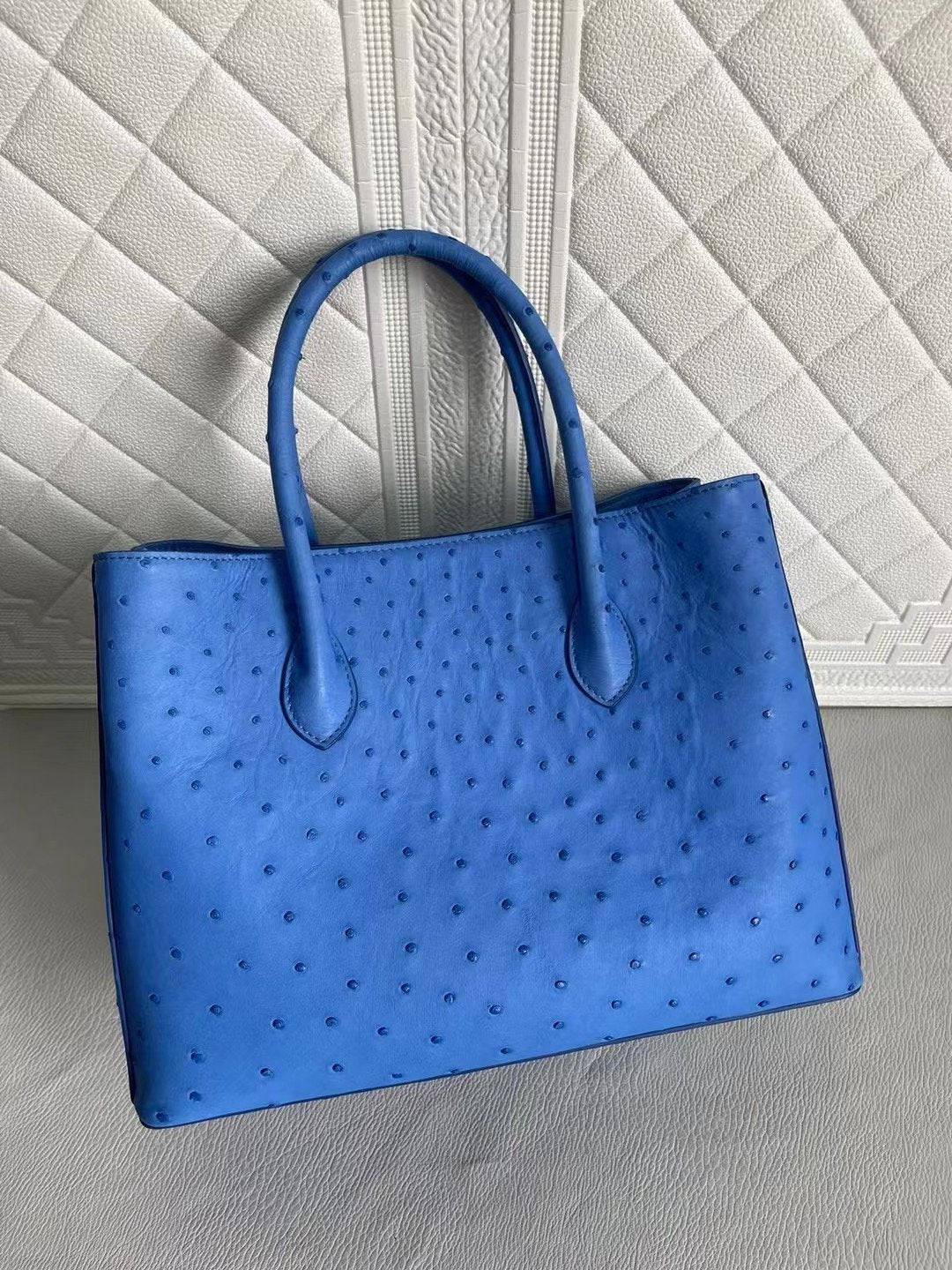 Blue and cream women's ostrich leather handbag with top handle and crossbody strap, 33cm, by Rossie Viren.