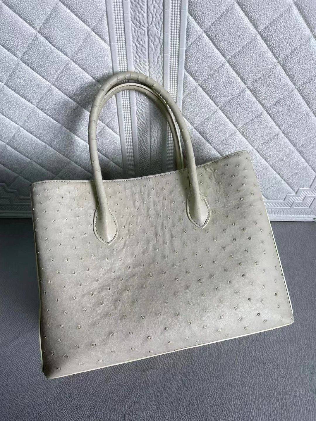 Blue and cream women's ostrich leather handbag with top handle and crossbody strap, 33cm, by Rossie Viren.