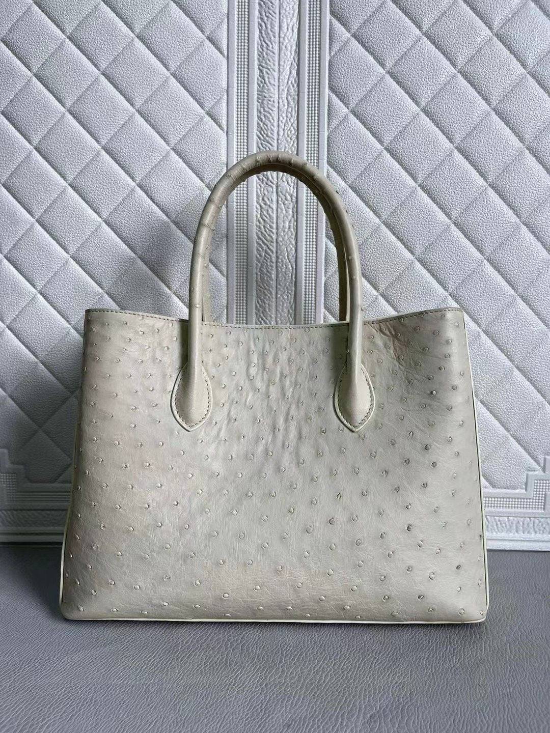 Women’s ostrich leather handbag by Rossie Viren featuring a blue and cream top handle, shoulder, and crossbody bag, 33cm wide.