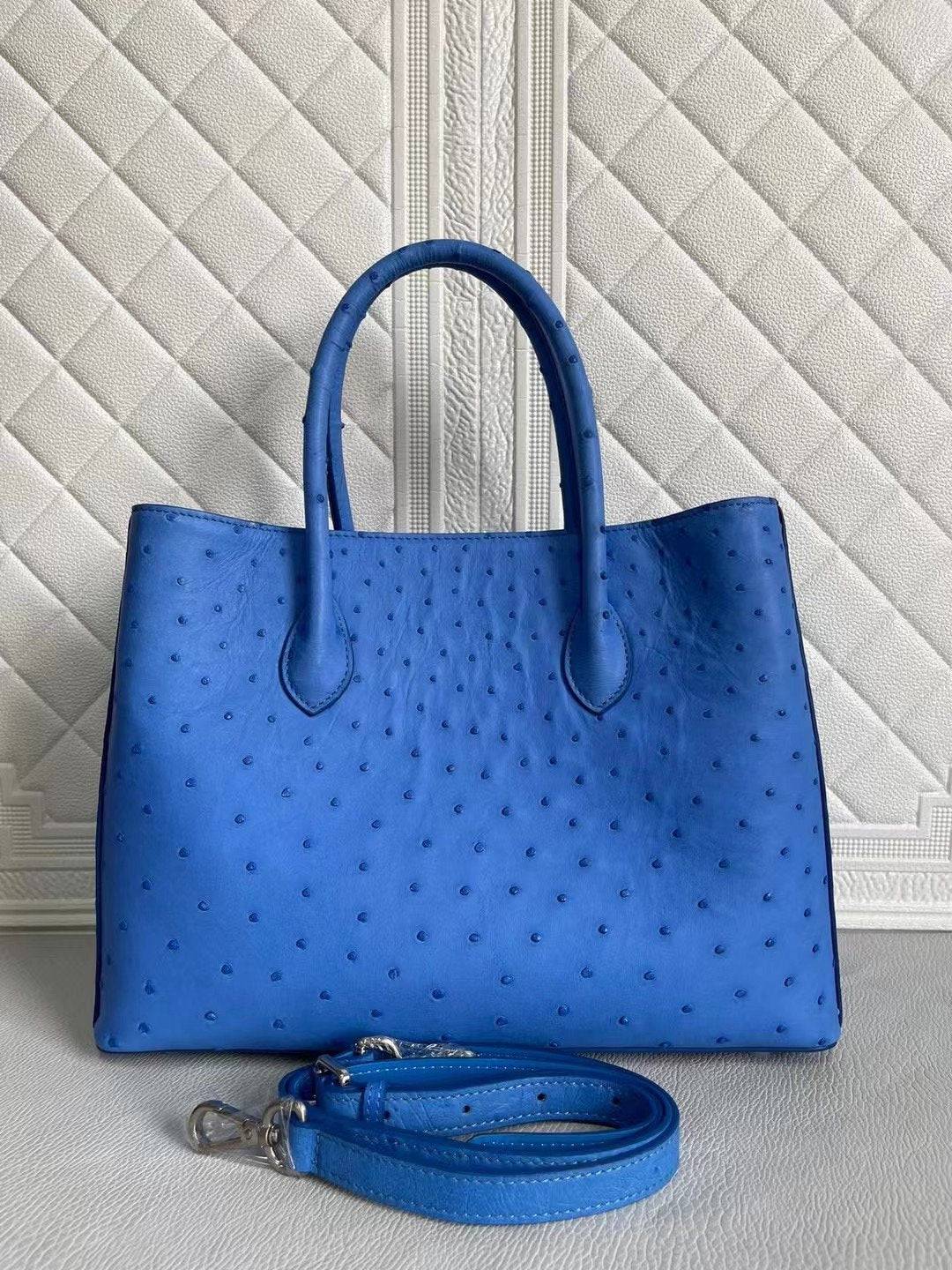 Women’s ostrich leather handbag with top handle and crossbody strap in blue and cream, 33cm, by Rossie Viren.