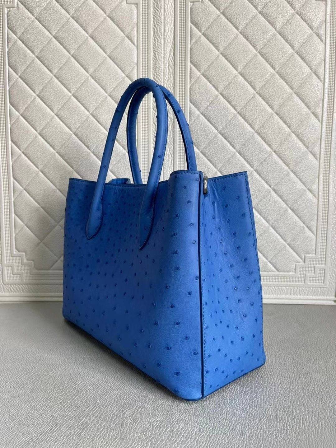 Blue and cream women's ostrich leather handbag with top handle and crossbody strap by Rossie Viren, 33cm.
