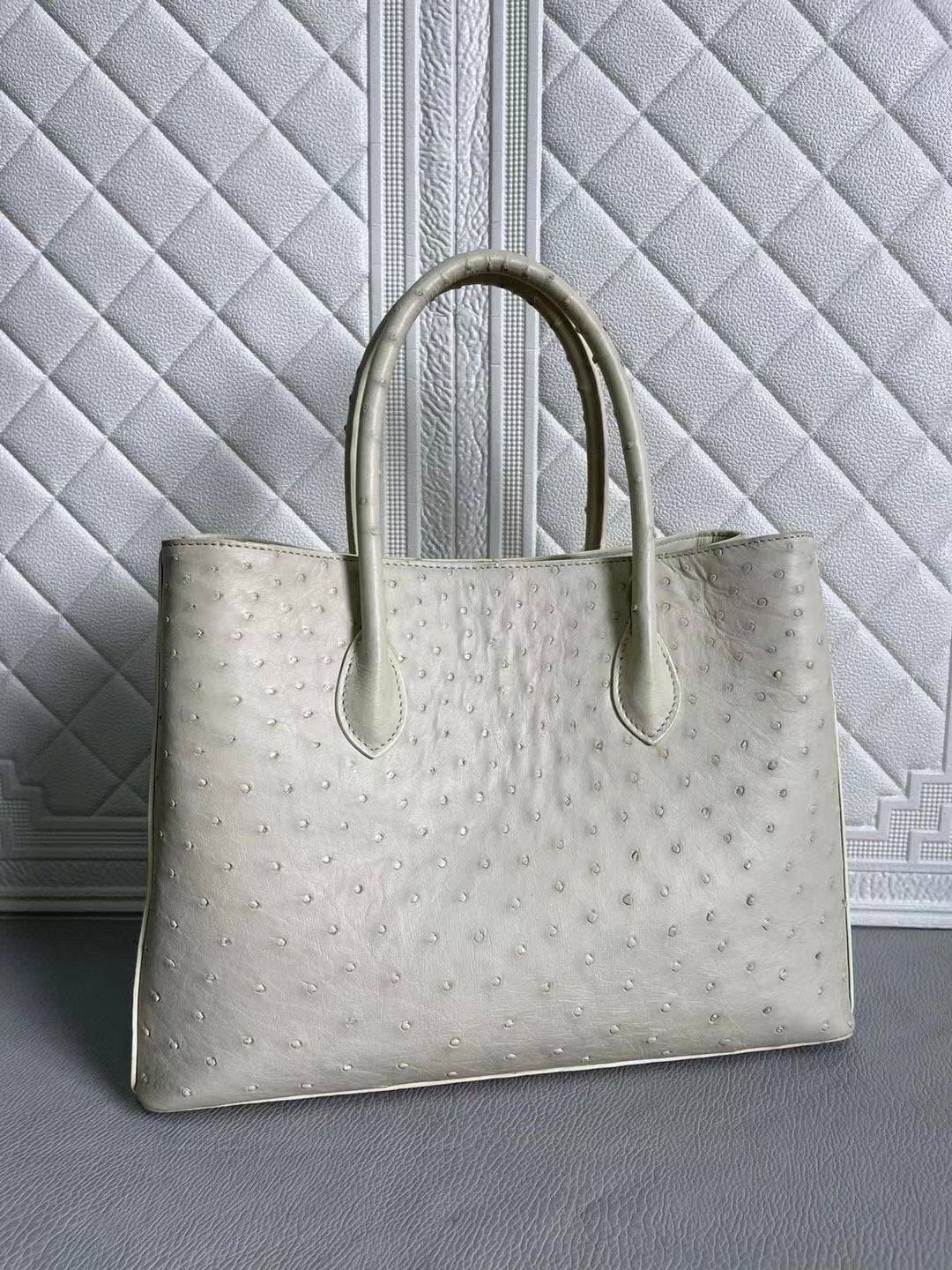 Women's ostrich leather handbag with top handle and crossbody strap in blue and cream, 33cm Rossie Viren bag.