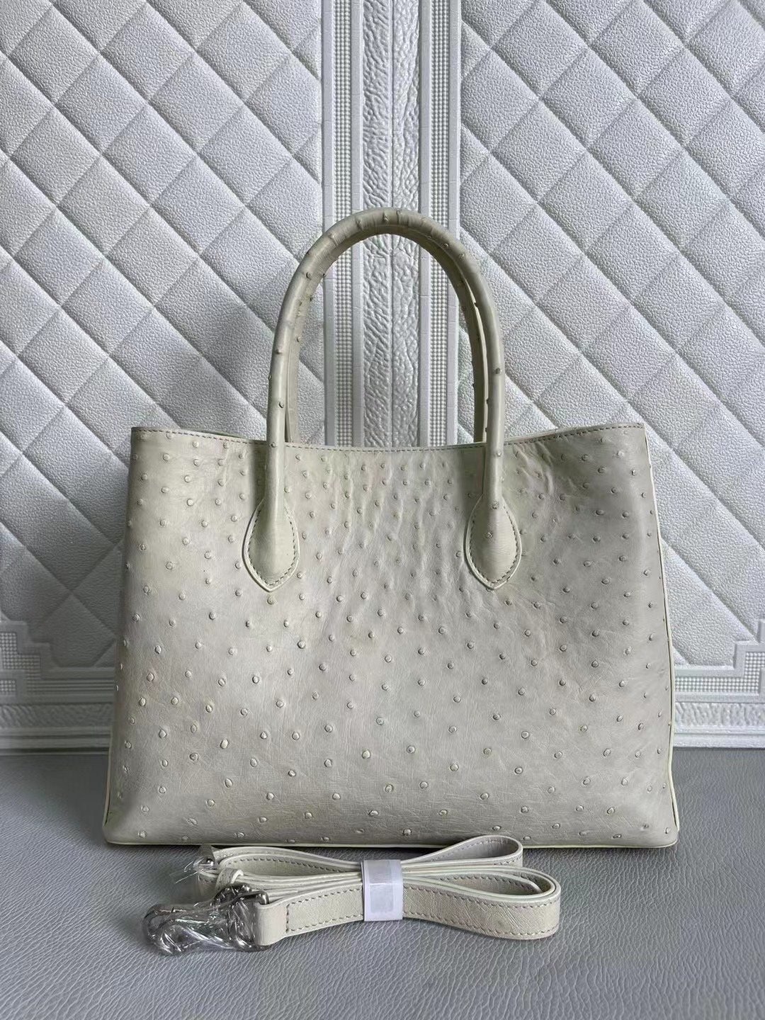 Blue and cream ostrich leather handbag with top handle and crossbody strap, 33cm, by Rossie Viren.