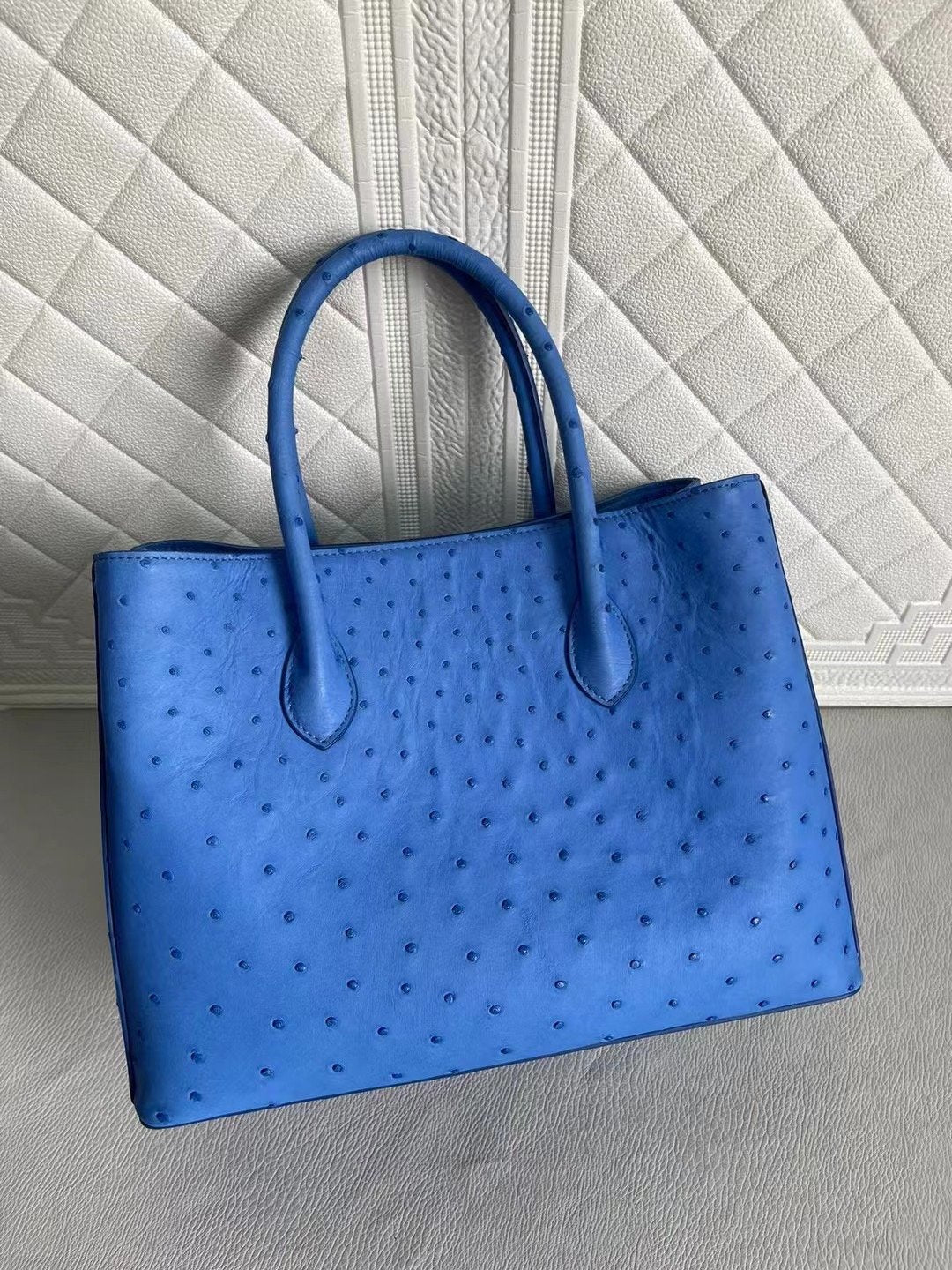 Blue and cream women's ostrich leather handbag with top handle and crossbody strap, 33cm, by Rossie Viren.