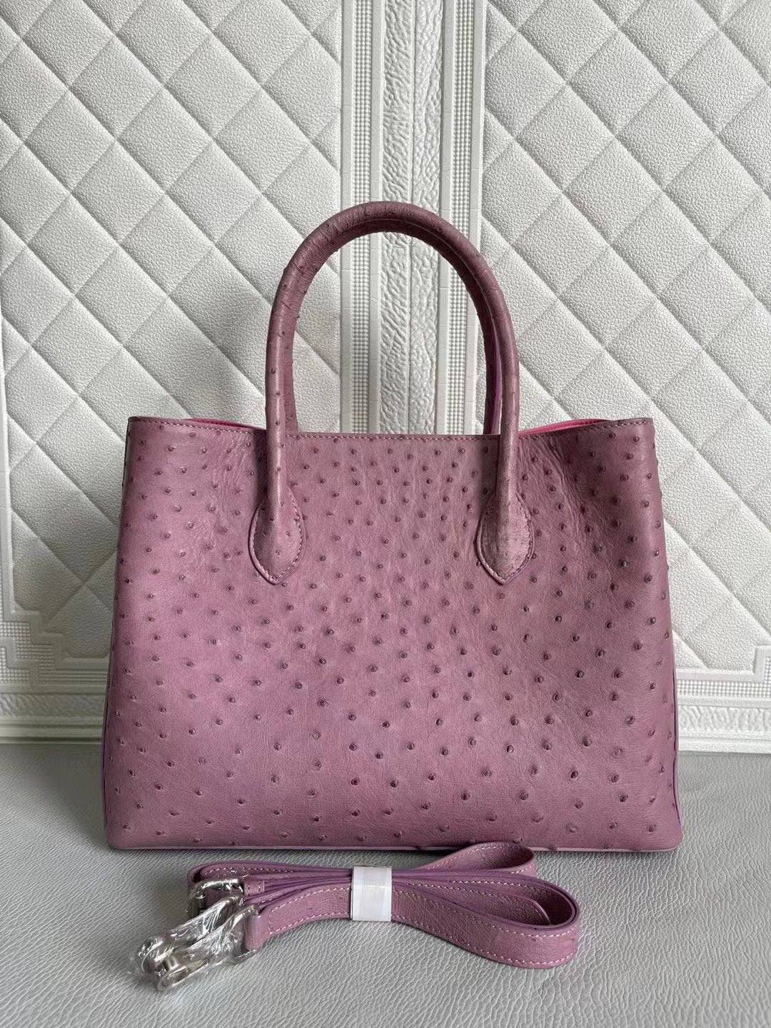 Women’s ostrich leather handbag by Rossie Viren with top handle and crossbody strap in blue and purple, 33cm size.