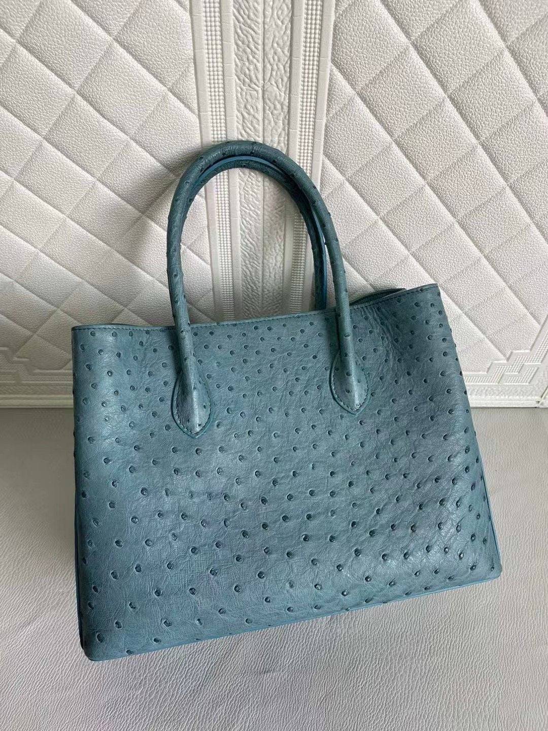Rossie Viren women's ostrich leather handbag with top handle and crossbody strap, in coral blue and yellow, 33cm.