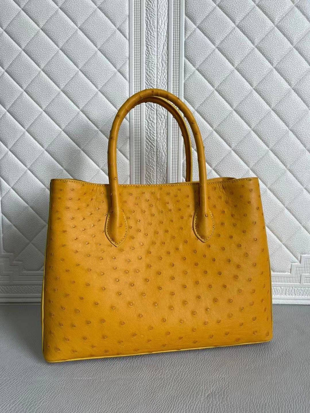 Rossie Viren women's ostrich leather handbag with top handle and crossbody strap in coral blue and yellow, 33cm size.
