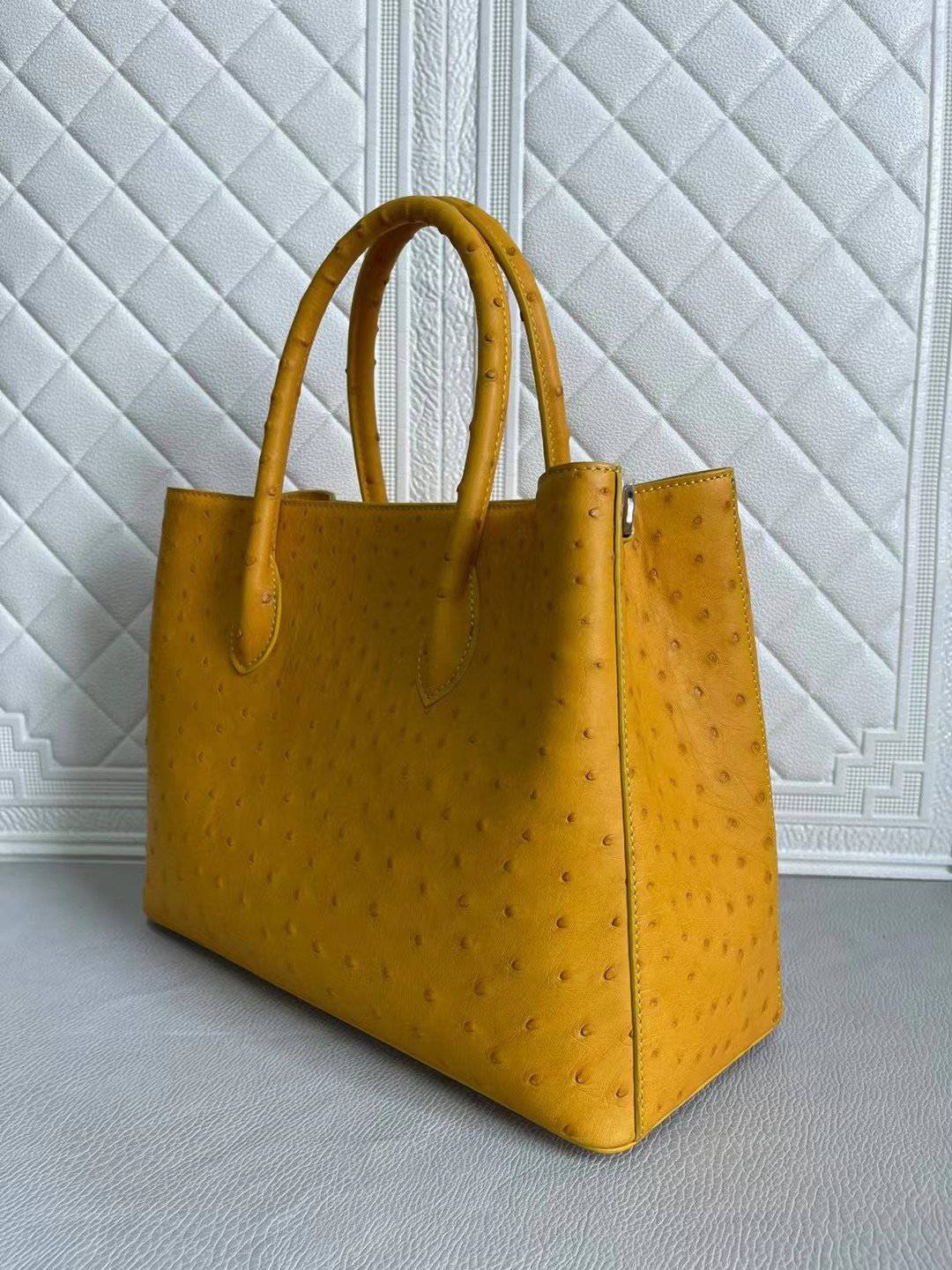 Rossie Viren women's ostrich leather handbag with top handle and crossbody strap in coral blue and yellow, 33cm size.