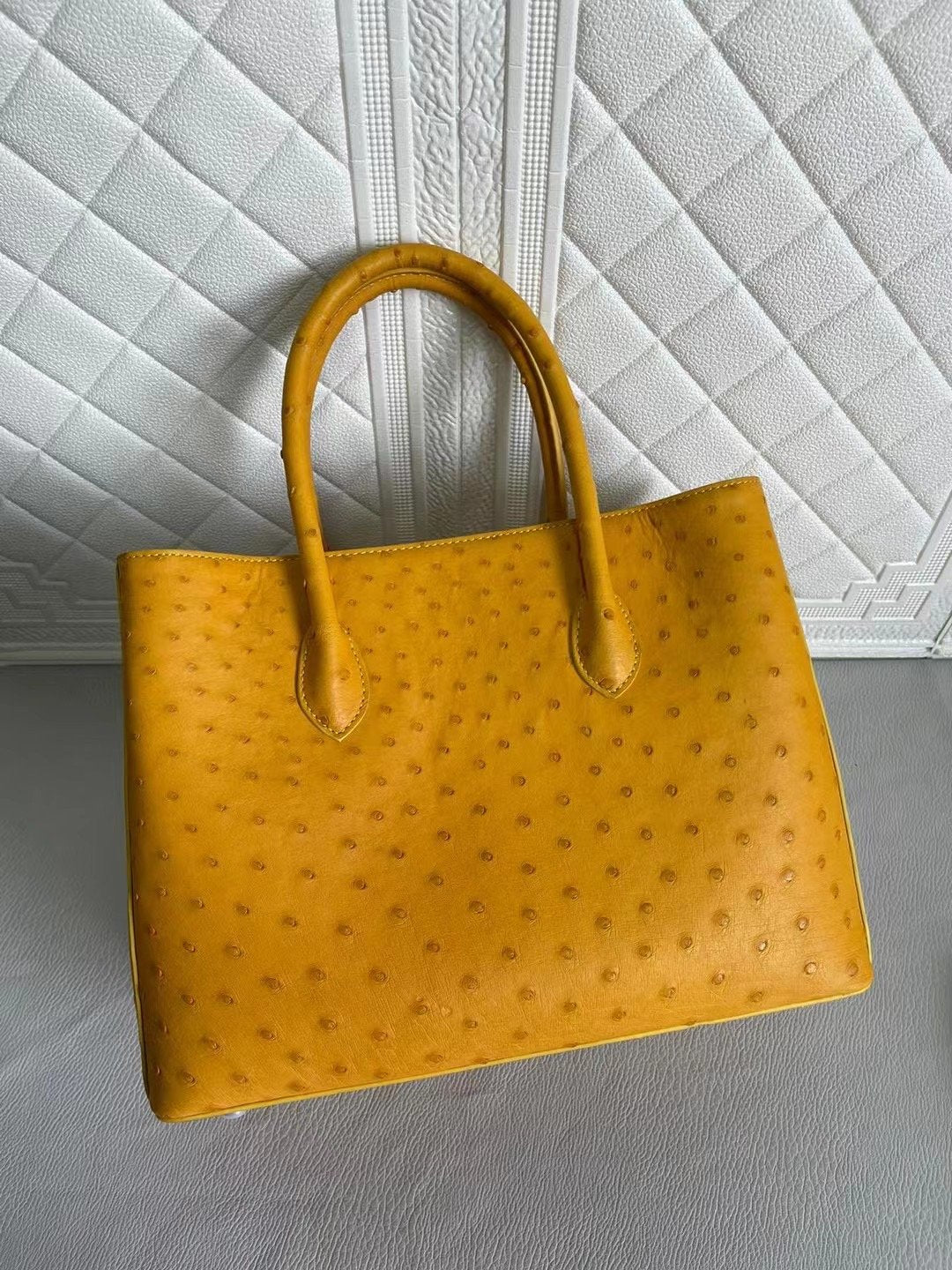 Rossie Viren women's ostrich leather handbag with top handle and crossbody strap in coral, blue, and yellow, 33cm size.