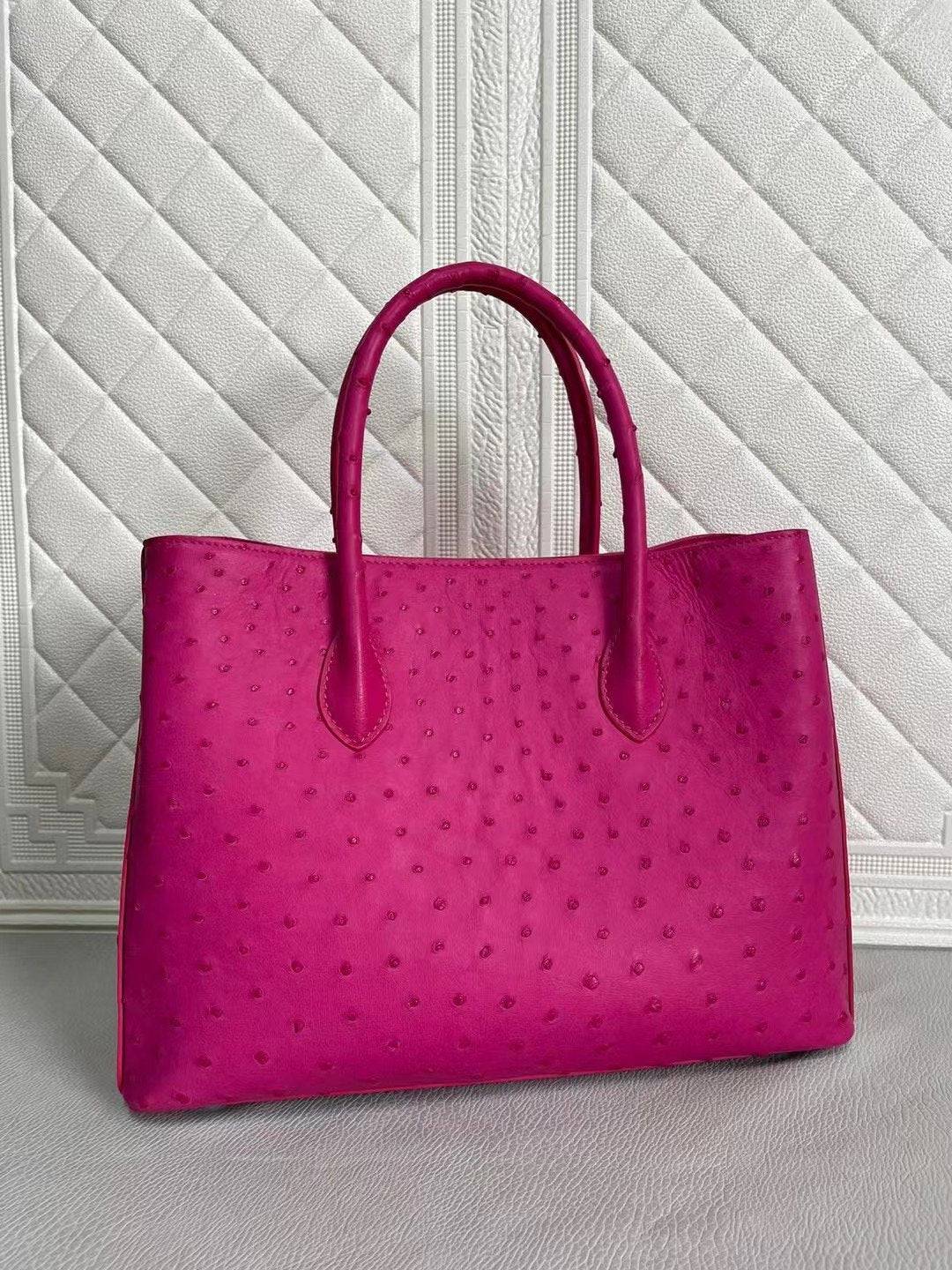 Rossie Viren women's ostrich leather handbag with top handle and crossbody strap in peach and green, 33cm size.