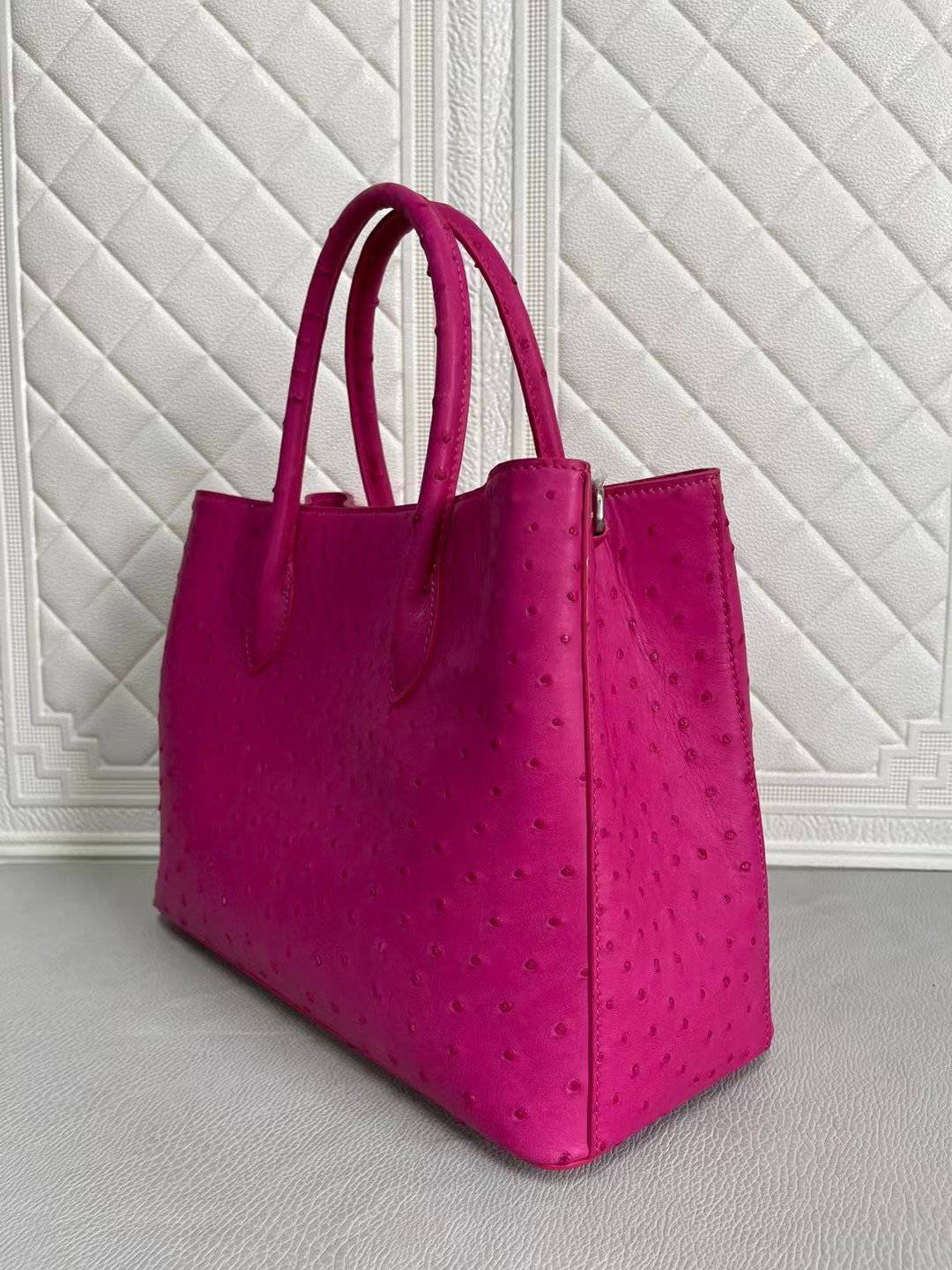 Women’s ostrich leather handbag with top handle and crossbody strap in peach and green, 33cm by Rossie Viren.