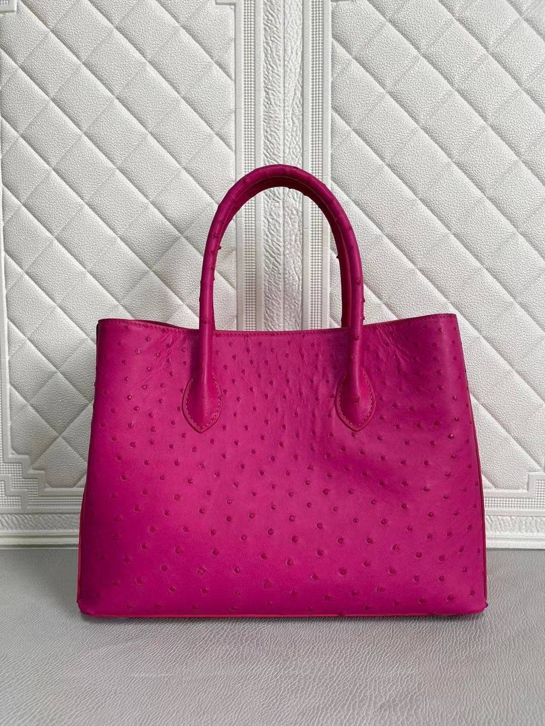 Women's ostrich leather handbag with top handle and crossbody strap in peach and green, Rossie Viren brand, 33cm size.