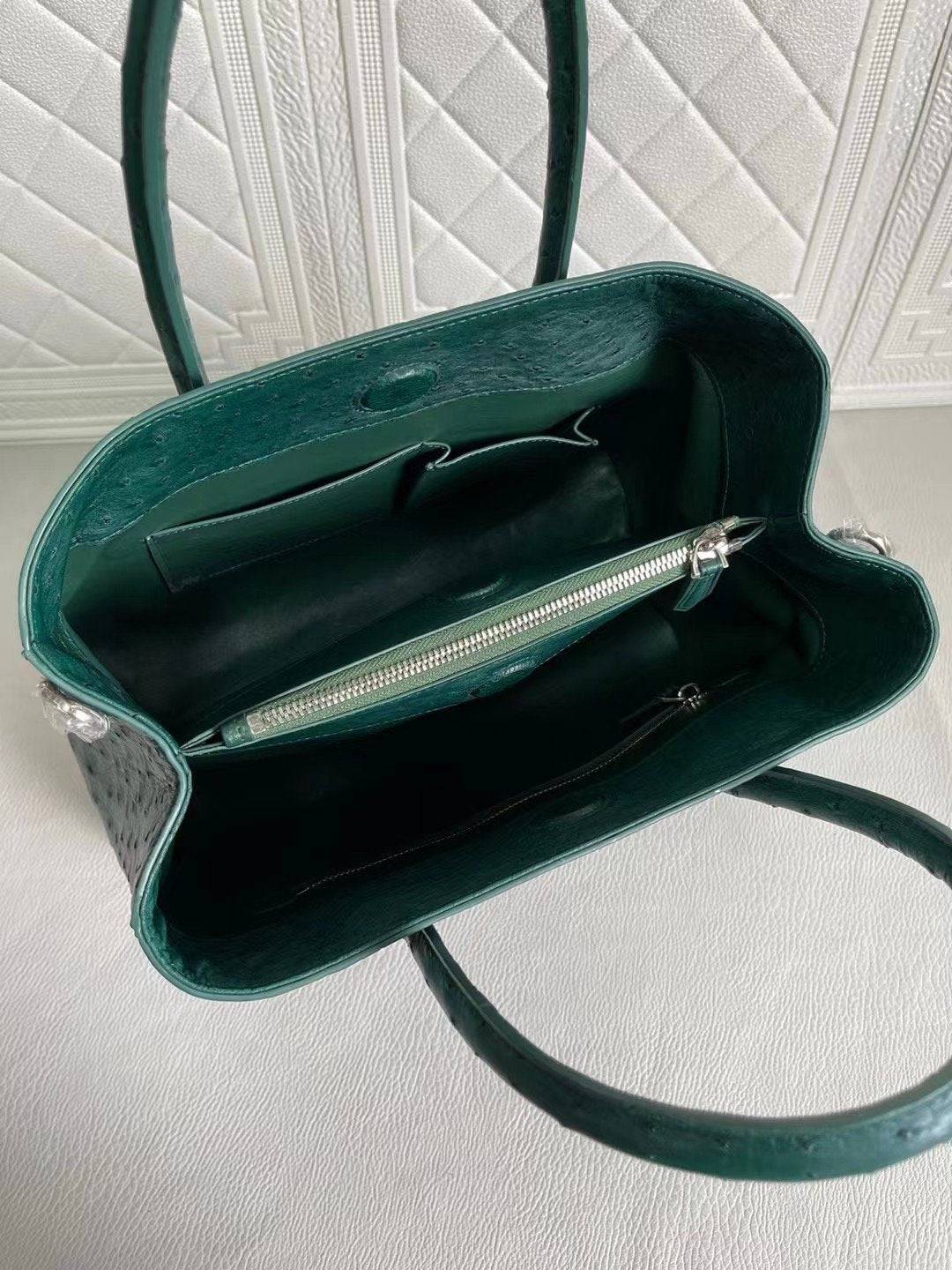 Rossie Viren women's ostrich leather handbag with top handle and crossbody strap in peach and green, 33cm wide.