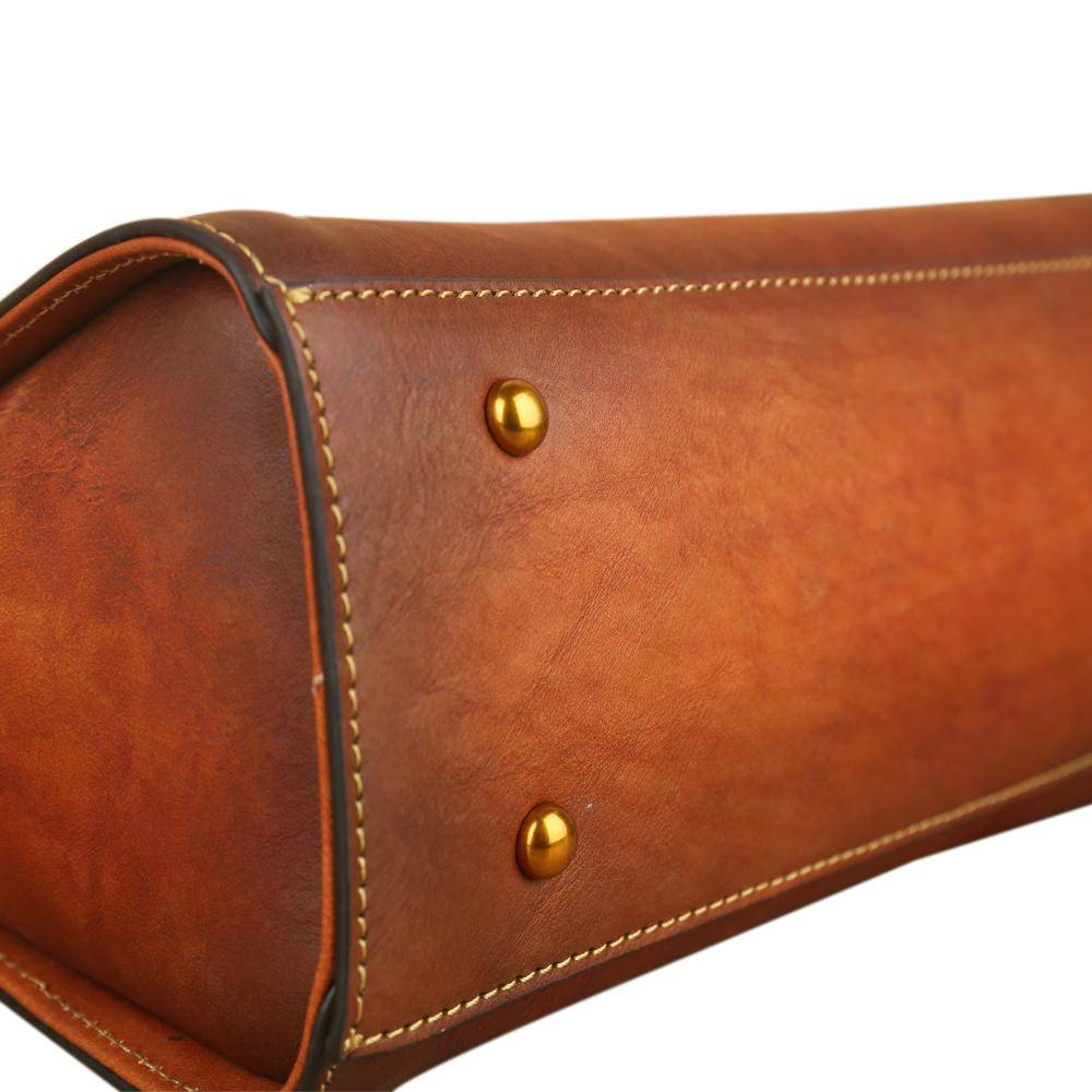 Women’s vintage leather tote handbag by Rossie Viren with small top-handle design and spacious interior.