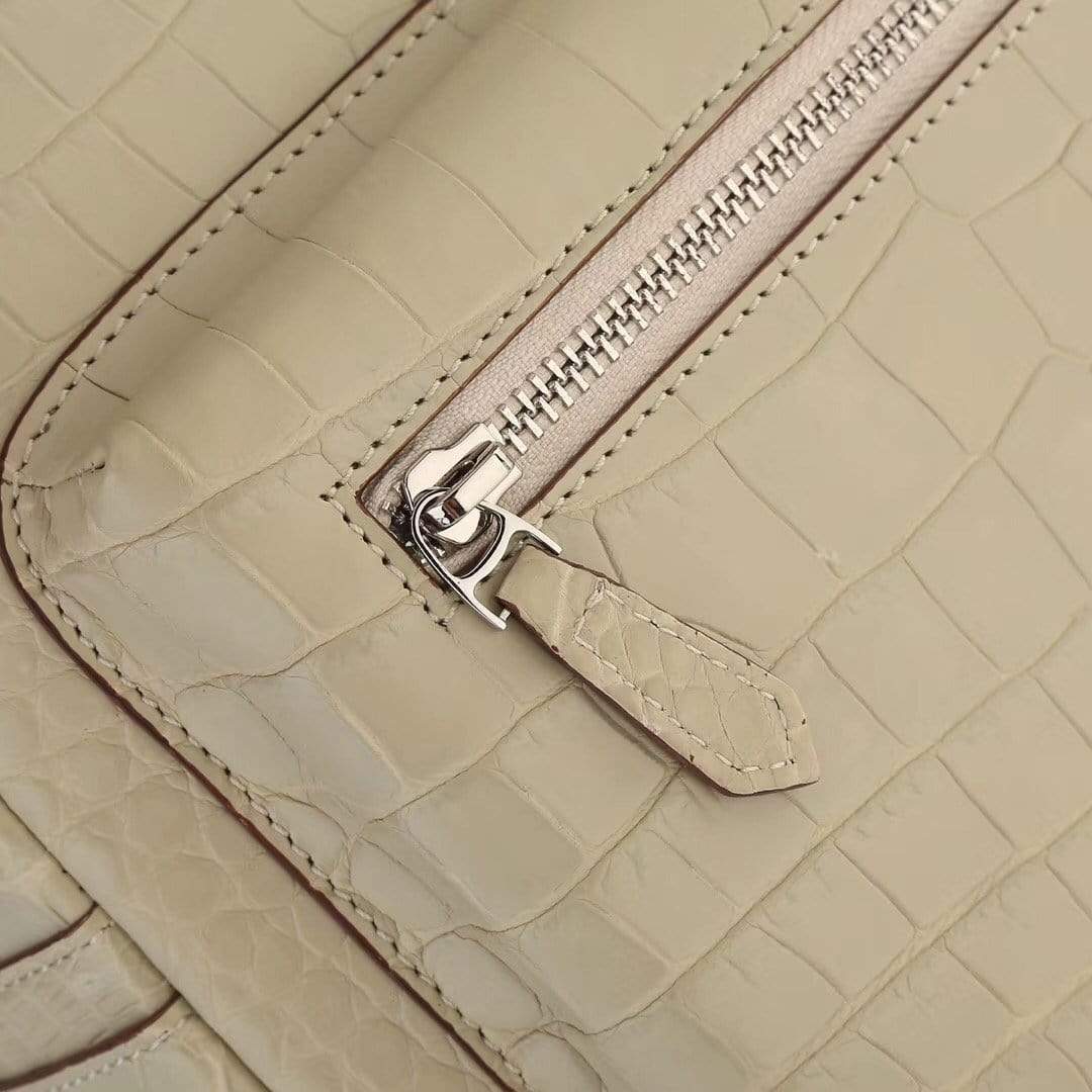 Cream crocodile leather backpack handbag for women by Rossie Viren, featuring a stylish textured crocodile pattern and adjustable straps.